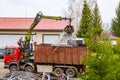 Skutec, Czech Republic, 21 November 2019: A grapple truck loads scrap industrial metal for recycling.