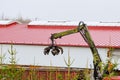 Skutec, Czech Republic, 21 November 2019: A grapple truck loads scrap industrial metal for recycling