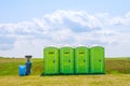 Skutech, Czech Republic, 26 June 2020: Portable toilet on the grass on a background of clouds