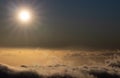 Sky above clouds with sun shining intensely