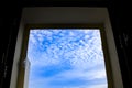 Sky with altocumulus floccus clouds through the window Royalty Free Stock Photo