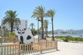 Sky, beach, sea, pedestrian walk and swings, San Antonio, Ibiza.