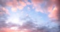 Sky with beautiful pink clouds and bright sunshine