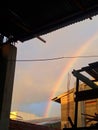 The sky with a beautiful rainbow and accompanied by neighboring houses