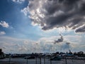The sky with black rain clouds behind the parking lot Royalty Free Stock Photo