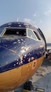 A blue and gold aircraft with the letter D on the nose soaring through the sky Royalty Free Stock Photo