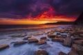 The sky clears after a rain storm just long enough to show the deep red and purple clouds over the South Dorset jurassic coastline Royalty Free Stock Photo