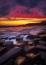 The sky clears after a rain storm just long enough to show the deep red and purple clouds over the South Dorset jurassic coastline Royalty Free Stock Photo