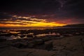 The sky clears after a rain storm just long enough to show the deep red and purple clouds over the South Dorset jurassic coastline Royalty Free Stock Photo