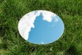 sky and cloud reflection in round mirror on grass Royalty Free Stock Photo