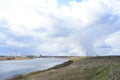 Sky, clouds. The Kostroma river flows meandering. Green grass on the banks of the river. In the distance, a forest, a village Royalty Free Stock Photo