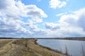 Sky, clouds. Meandering river. On the banks of the river, trees, shrubs, grass. Forest in the distance. Rural view Royalty Free Stock Photo