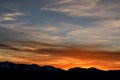 Sky clouds mountains sunset fiery Royalty Free Stock Photo