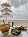 Dinner on the sky with clouds over the blue sea and china umbrella