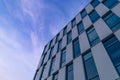 Sky with clouds reflected in windows of modern office building. Business background Royalty Free Stock Photo