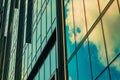 Sky with clouds reflected in windows of modern office building. Colorful background Royalty Free Stock Photo