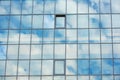 Sky and clouds reflected in the windows of a modern office building, glass building Royalty Free Stock Photo