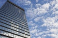 Sky and clouds reflecting in skyscraper windows low angle view Royalty Free Stock Photo
