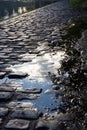 Sky and clouds reflection on puddle in he rock cose to a lake