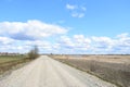 Sky, clouds, river. Village road. Far village and forest. A large field of young grass, boundless. Agricultural