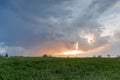 Sky with clouds and sun over fild at sunset