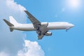 Sky with clouds and sun, reflected glare light, and passenger airplane landing approach airport