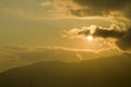 Sky with clouds and sun. Storm clouds and orang sky. Sunlight rays in reflects clouds. Looking up view of panorama. Nature Royalty Free Stock Photo