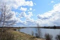 Sky, clouds. Trees, shrubs, grasses on the banks of the river. The course of a winding river. Rural view Royalty Free Stock Photo