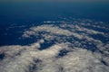 The sky and clouds and the view seen in the window of the plane. Royalty Free Stock Photo