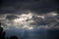 the sky is dark with black clouds and sunshine, in the evening Royalty Free Stock Photo