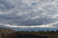 Sky with dense clouds over agricultural fields at autumn evening Royalty Free Stock Photo