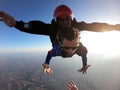 Sky dive tandem friends at the sunset Royalty Free Stock Photo