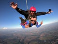 Sky dive tandem friends at the sunset Royalty Free Stock Photo