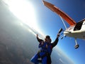 Sky dive tandem friends at the sunset Royalty Free Stock Photo