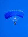 Sky diver with blue parachute