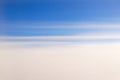 Sky divided by the blue and white with elongated clouds. Royalty Free Stock Photo