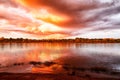 Sky with fantastic, amazing, stormy, disturbing red clouds over the river on a summer or autumn evening Royalty Free Stock Photo