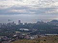 Sky filled with layers of light and shadow, Vivid cloud formations extending over urban coast and water Royalty Free Stock Photo