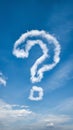 Sky with fluffy clouds, prominent question mark shaped cloud evokes curiosity Royalty Free Stock Photo