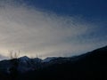 Sky full of clouds over the mountain. dramatic evening skywill with much wind moving clouds over the shihuettes of shrubs and moun Royalty Free Stock Photo