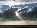 Sky with giants cumulonimbus clouds and sun rays through over the sea Royalty Free Stock Photo