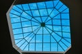 Sky through the glass window at the top of the building. Modern window in the roof of the building, designed for natural light and Royalty Free Stock Photo