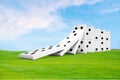 Dominoes on grass and sky background, about to