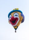 In the sky hot air balloon in the shape of a clown`s head at the hot air balloon festival