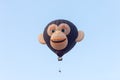 In the sky hot air balloon in the shape of head of a monkey withIn the sky hot air balloon in the shape of head of a monkey with t