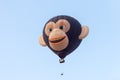 In the sky hot air balloon in the shape of head of a monkey withIn the sky hot air balloon in the shape of head of a monkey with t