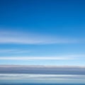 The wispy white clouds are softly dispersed at varying altitudes Royalty Free Stock Photo