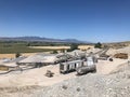 Aggregate rock crushing plant set up in with conveyors and screening plant and crusher and jaw.  Beautiful summer sky. Royalty Free Stock Photo