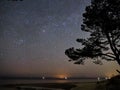 Night sky and milky way stars, Perseus and Cassiopeia constellation over sea