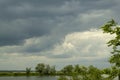 The sky is overcast before the rain. Gray storm clouds in the sky above the river Royalty Free Stock Photo
